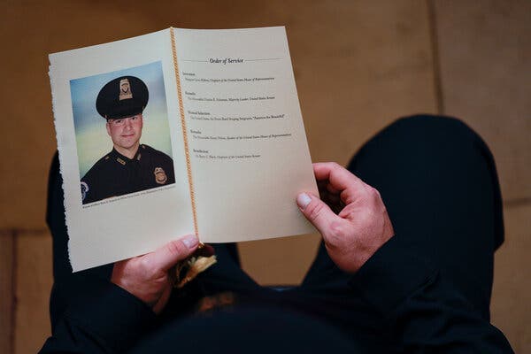 A Capitol Police officer holding a program for the ceremony memorializing Officer Brian D. Sicknick in the Rotunda of the Capitol on Feb. 3.